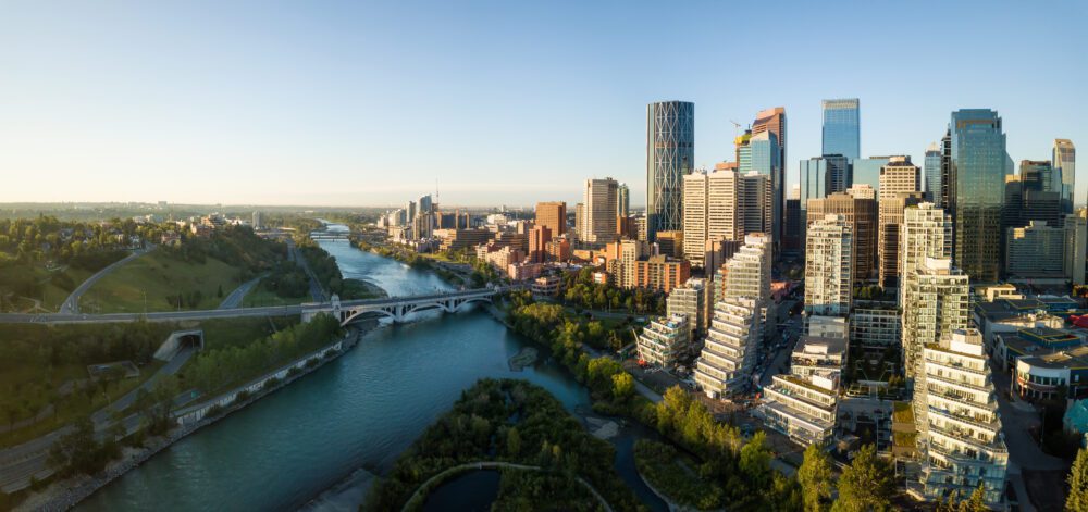 Aerial panoramic view of a beautiful modern cityscape during a vibrant sunny sunrise. Taken in Calgary Downtown, Alberta, Canada.