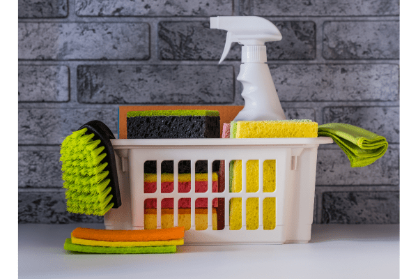 Household cleaning supplies in a plastic tote