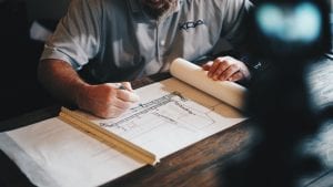 Architect editing blueprints on a desk