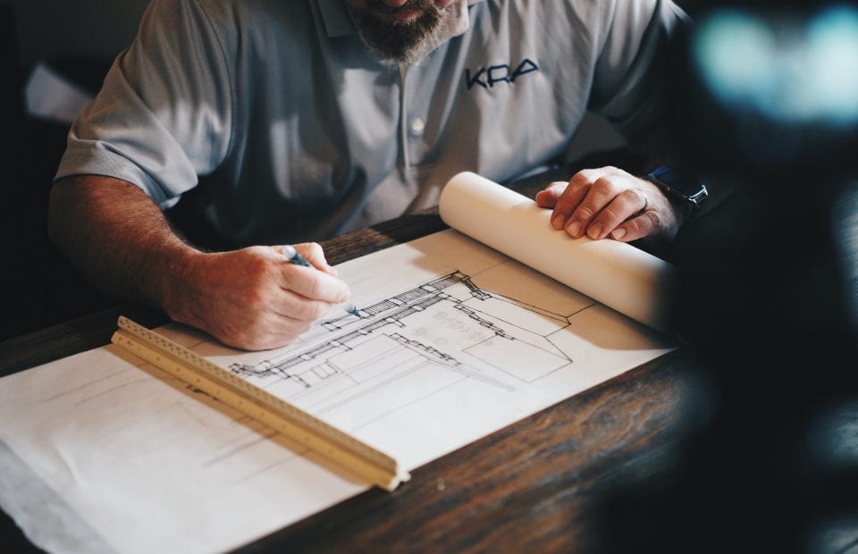 Architect editing blueprints on a desk