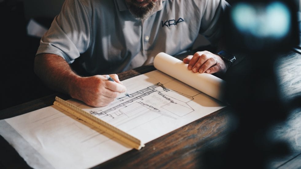 Architect editing blueprints on a desk