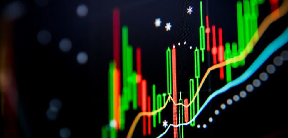 A cryptocurrency digital trading chart on a screen showing peaks and troughs.